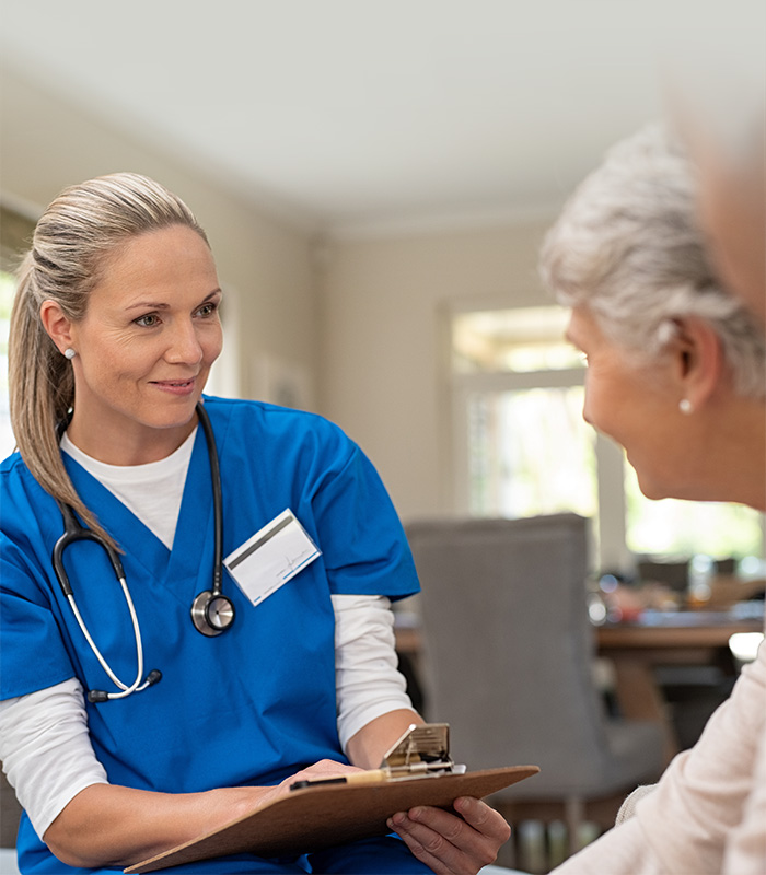 a caregiver with an elderly couple in a in their home